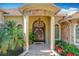 Elegant front entrance with stone columns, arched doorway, and a chandelier at 1502 Hempel Ave, Windermere, FL 34786