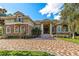 Stunning home featuring a brick driveway, stone accents, and arched windows at 1502 Hempel Ave, Windermere, FL 34786