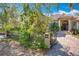 Home featuring lush landscaping, an iron gate, and stone mailbox at 1502 Hempel Ave, Windermere, FL 34786