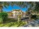 Gated entrance leading to a landscaped property with mature trees and lush greenery at 1502 Hempel Ave, Windermere, FL 34786