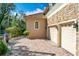 Attached two-car garage featuring brick pavers and exterior stone accents at 1502 Hempel Ave, Windermere, FL 34786