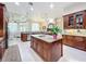 Bright kitchen showcases a large island with granite countertops, custom cabinets, and modern stainless appliances at 1502 Hempel Ave, Windermere, FL 34786