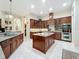 Bright kitchen featuring granite countertops, stainless steel appliances, and custom wood cabinetry at 1502 Hempel Ave, Windermere, FL 34786