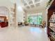 Bright living room with fireplace, coffered ceilings, tile floors, and views of the screened-in pool at 1502 Hempel Ave, Windermere, FL 34786