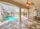 Enclosed pool area featuring palm trees and a stone floor at 1502 Hempel Ave, Windermere, FL 34786