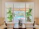 Close-up of pool view, with furniture, plants, and glass table at 1502 Hempel Ave, Windermere, FL 34786