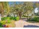 Scenic street view with mature trees, lush vegetation, and a glimpse of the lake at 1502 Hempel Ave, Windermere, FL 34786