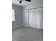 Bright bedroom featuring gray vinyl flooring and large closet doors at 15081 Sw 35Th Cir, Ocala, FL 34473