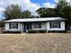 Charming single-story home featuring a well-maintained lawn and a welcoming entrance at 15081 Sw 35Th Cir, Ocala, FL 34473