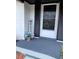 Close up of front porch with gray painted floors and front door at 15081 Sw 35Th Cir, Ocala, FL 34473