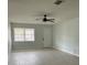 Open-concept living space with ceiling fan and modern gray vinyl flooring at 15081 Sw 35Th Cir, Ocala, FL 34473