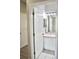 Bathroom with a modern vanity, sink, and mirror, viewed through an open doorway at 1746 Golfview Drive, Kissimmee, FL 34746