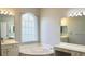 Bathroom with soaking tub, dual sinks, vanities, and large mirrors at 1746 Golfview Drive, Kissimmee, FL 34746