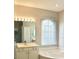 Well-lit bathroom featuring a soaking tub and large vanity at 1746 Golfview Drive, Kissimmee, FL 34746