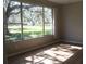 Bedroom featuring a large window with a view of the green outdoor landscape at 1746 Golfview Drive, Kissimmee, FL 34746