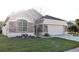 View of the home's exterior showcasing the stone accents and large window at 1746 Golfview Drive, Kissimmee, FL 34746