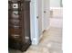 Hallway featuring wood floors, a dark wood dresser, and entryways to bathrooms at 1746 Golfview Drive, Kissimmee, FL 34746