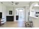 Bright living room with hardwood floors flows into the foyer with a view of the kitchen at 1746 Golfview Drive, Kissimmee, FL 34746