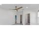 Bright main bedroom with a ceiling fan, and en-suite bathroom and walk-in closet at 1751 Sereno Dr, Davenport, FL 33896