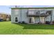 Backyard featuring green grass and sliding glass doors leading to a balcony at 1897 Caralee Blvd # 2, Orlando, FL 32822