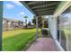 View of the backyard with lawn, fencing, and a glimpse of the apartment complex at 1897 Caralee Blvd # 2, Orlando, FL 32822