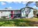 Inviting two-story apartment building features well-maintained landscaping and bright exterior paint at 1897 Caralee Blvd # 2, Orlando, FL 32822