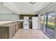 Kitchen featuring dark cabinetry and white appliances at 1897 Caralee Blvd # 2, Orlando, FL 32822