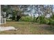 Large backyard with mature trees and some grass at 19 N Van Buren Ave, Orlando, FL 32811