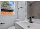 This bathroom features gray tile, updated white vanity and black fixtures at 19 N Van Buren Ave, Orlando, FL 32811