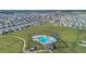 Overhead shot of a community pool, playground, and surrounding neighborhood at 1934 Pond Pine Ct, Haines City, FL 33844