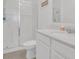 Clean bathroom with a walk-in shower, white cabinets, and stone countertop at 1934 Pond Pine Ct, Haines City, FL 33844