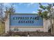 Cypress Park Estates entrance sign surrounded by lush landscaping and bright blue skies at 1934 Pond Pine Ct, Haines City, FL 33844