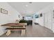 Bright and airy living room featuring neutral tones, tile flooring, and backyard access at 1934 Pond Pine Ct, Haines City, FL 33844