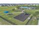 Aerial view of community playground with swings, slide, and shaded benches at 1934 Pond Pine Ct, Haines City, FL 33844