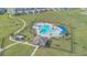 Aerial view of community pool, lounge area, and palm trees at 1934 Pond Pine Ct, Haines City, FL 33844