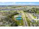 An aerial view showing community sports courts and a lush greenbelt adjacent to a residential neighborhood at 1982 Cricket Cradle Dr, Kissimmee, FL 34746