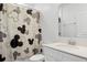 Bathroom with Mickey Mouse shower curtain and simple single sink vanity and white cabinets at 1982 Cricket Cradle Dr, Kissimmee, FL 34746