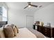 Bedroom featuring a ceiling fan, dresser, natural light, and neutral decor at 1982 Cricket Cradle Dr, Kissimmee, FL 34746