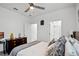 Well-lit bedroom with a ceiling fan, natural light, and neutral colors at 1982 Cricket Cradle Dr, Kissimmee, FL 34746