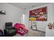 Playroom with a pink tent, a toy kitchen, a Happy Birthday tapestry and a cozy chair at 1982 Cricket Cradle Dr, Kissimmee, FL 34746