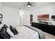 Well-lit bedroom featuring a plush bed, dark dresser, and ensuite bathroom access at 1982 Cricket Cradle Dr, Kissimmee, FL 34746