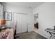 Office space with grey carpeting, a multi-door closet, and an adjacent doorway leading to another space at 1982 Cricket Cradle Dr, Kissimmee, FL 34746