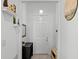 Bright foyer with a white door, tiled floor, and decor on the walls and shelving at 1982 Cricket Cradle Dr, Kissimmee, FL 34746