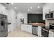 Modern kitchen featuring stainless steel appliances, tiled floor, and white cabinetry at 1982 Cricket Cradle Dr, Kissimmee, FL 34746