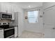 Well lit kitchen area with stainless steel appliances and view of a large window at 1982 Cricket Cradle Dr, Kissimmee, FL 34746