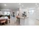 Open-concept kitchen featuring white cabinets, gray countertops, a kitchen island with seating, and modern appliances at 1982 Cricket Cradle Dr, Kissimmee, FL 34746