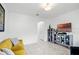 Bright living room with tiled floors, a yellow sofa and an entertainment center at 1982 Cricket Cradle Dr, Kissimmee, FL 34746