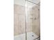 Close up of shower stall featuring tiled walls, glass door and multi-setting shower head at 1982 Cricket Cradle Dr, Kissimmee, FL 34746