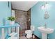 Blue themed bathroom featuring a tiled shower, decorative accents, and a modern sink at 200 El Camino Dr # 402, Winter Haven, FL 33884