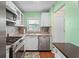 Cozy kitchen with stainless steel appliances, tiled backsplash, a sink under the window, and white cabinetry at 200 El Camino Dr # 402, Winter Haven, FL 33884